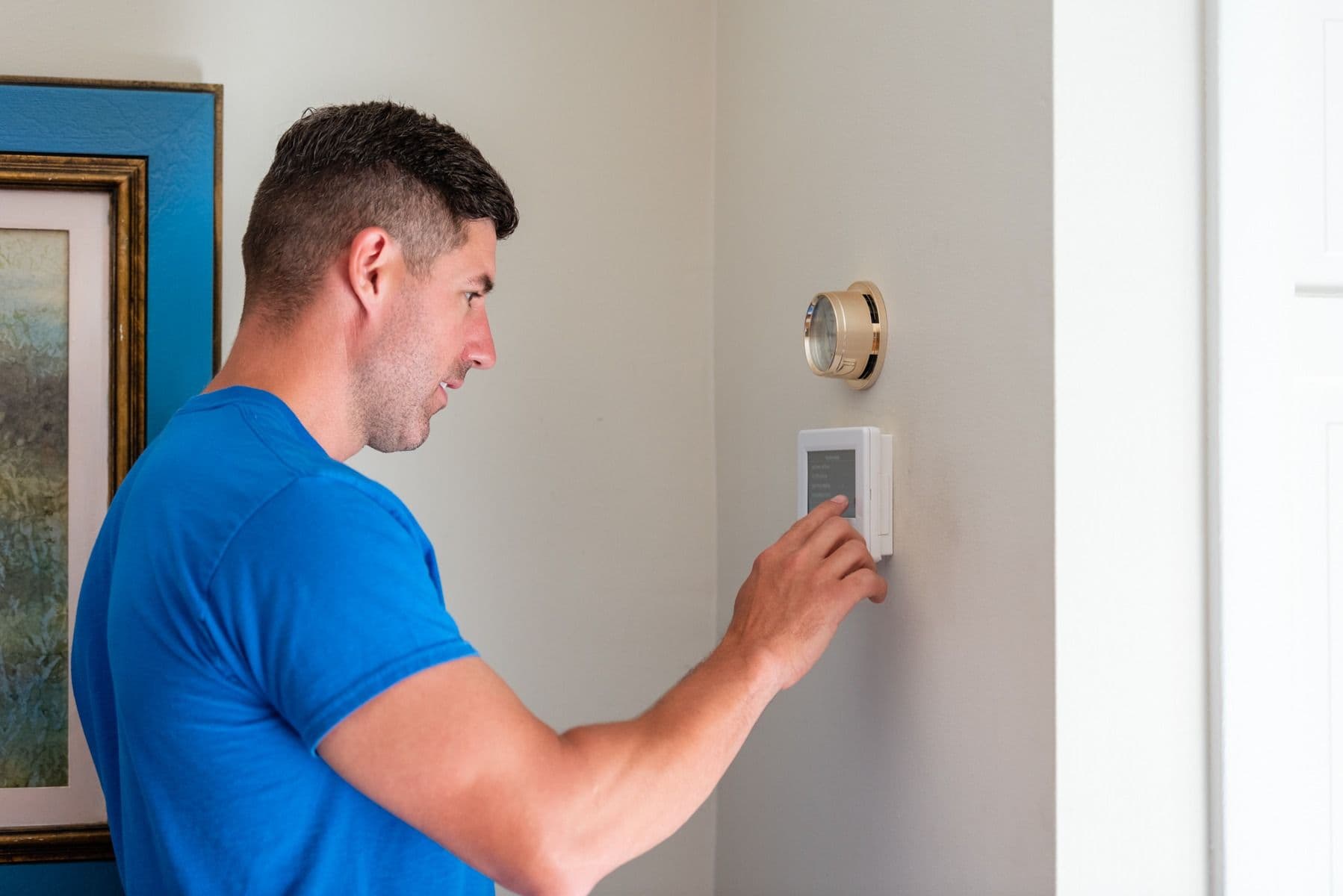 HVAC-Technician-Luke-Adjusting-Thermostat-Philadelphia-Gas-Electric-Heating